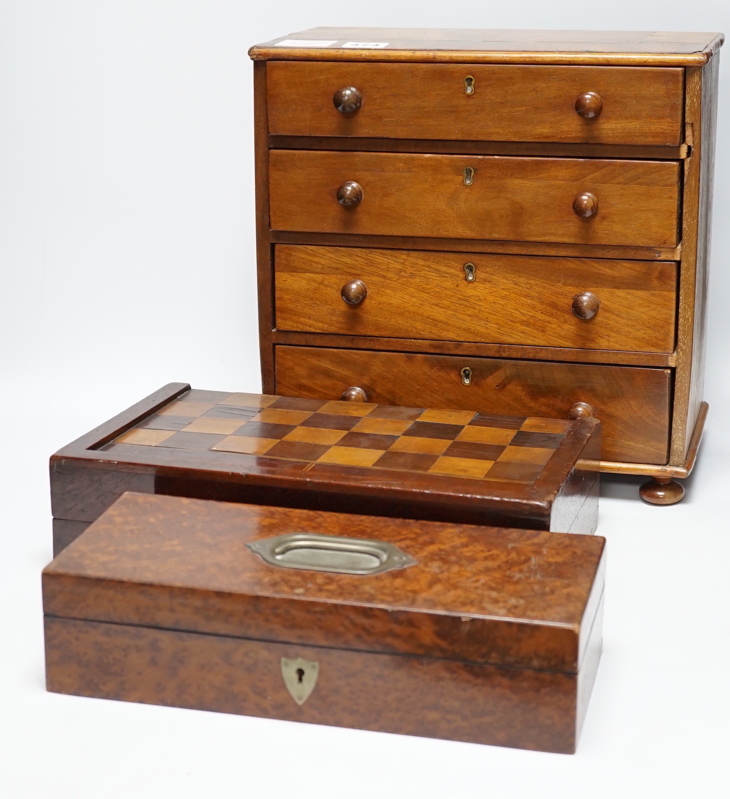 A Victorian mahogany miniature four draw chest, an amboyna glove box and a games box